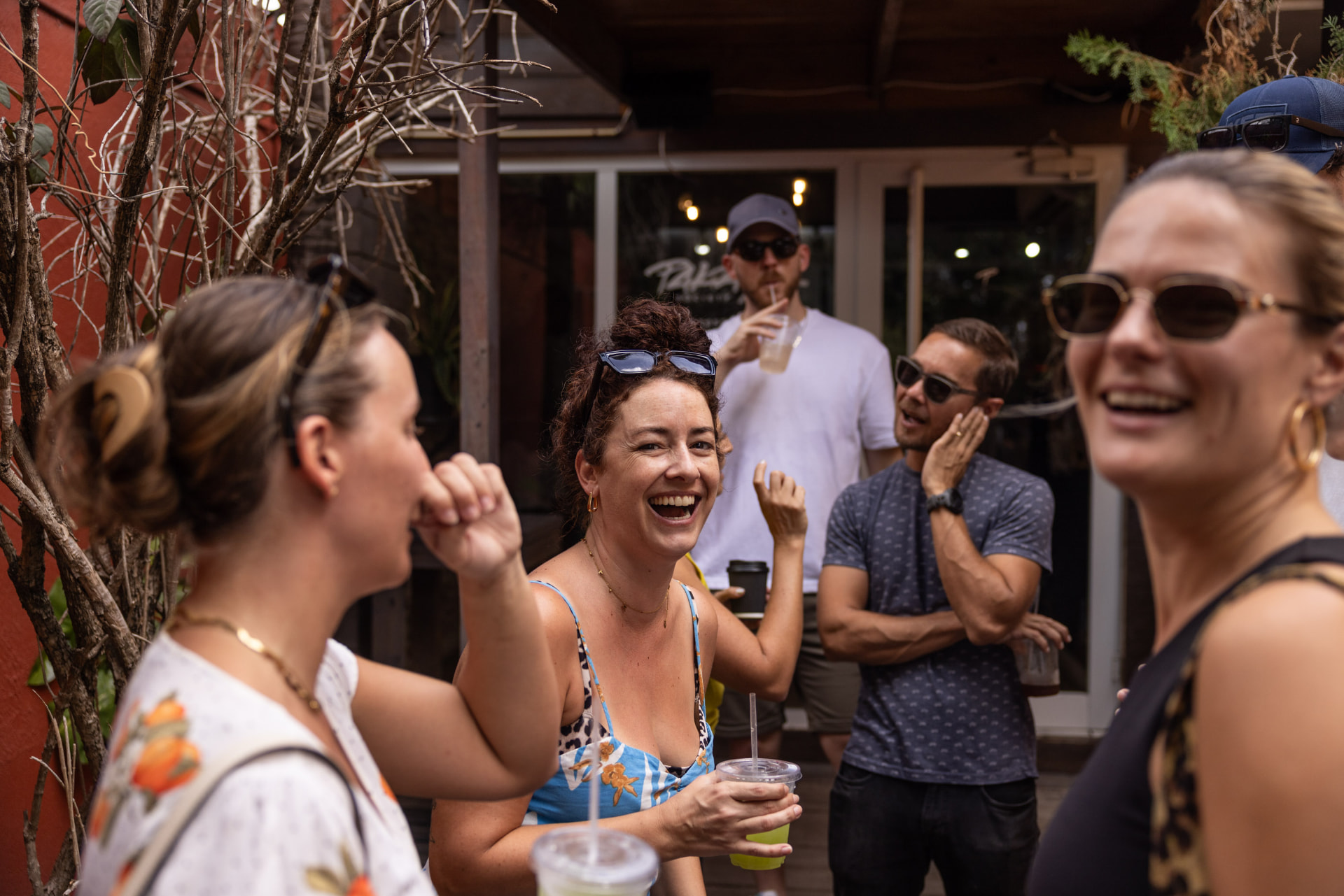 Neighbors laughing outside Pakaya Society