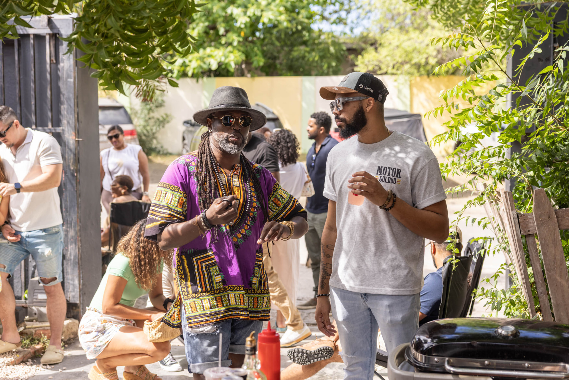 Friends talking in the Pakaya Society yard